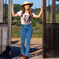 Mulher com Calça Jeans e Camisa da Maragata abrindo o portão